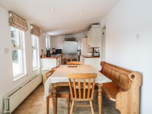 a kitchen with a table and chairs in a room at Newlands in Archiestown