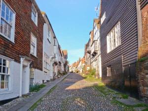 an empty street in an old city with buildings at The Old Forge in Rye