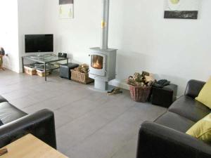 a living room with a fireplace and a couch at Mountain View in Conwy
