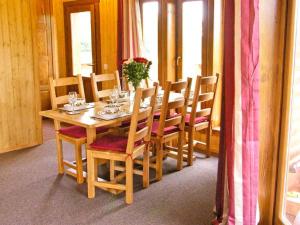 a wooden dining room table with chairs and a table at Lake View Lodge in Shepton Mallet