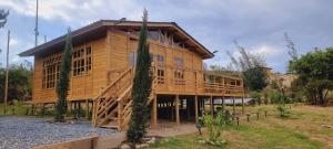 a large wooden house with a staircase in front of it at EcoChalet Luxury in Ráquira