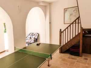 a room with a ping pong table and a chair at The Old Stable in Weston-super-Mare
