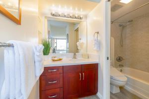 a bathroom with a sink and a toilet and a tub at Mountain View Getaway, Free Parking and Beach Steps Away in Honolulu