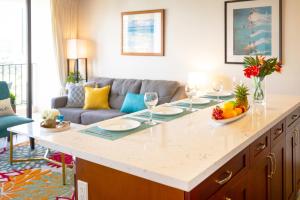 a living room with a kitchen island with wine glasses at Mountain View Getaway, Free Parking and Beach Steps Away in Honolulu