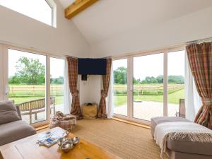 a living room with large windows and a couch at The Stables in Telford