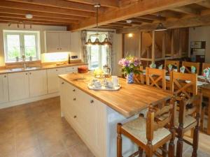 a kitchen with a wooden counter and a dining room at The Old Mill in Llanfihangel Rhydithon