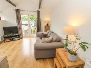 a living room with a couch and a television at The Potting Shed in Carnforth