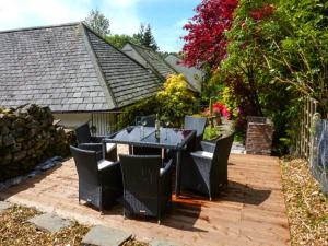 a dining table and chairs on a patio at The Nook in Windermere