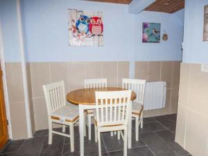 a dining room with a table and four chairs at Chapel Cottage in Whitby +5 photos