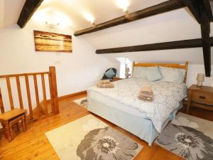 a bedroom with a bed and a wooden floor at Snowdon View in Holyhead