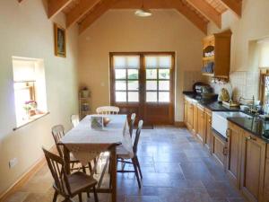 a kitchen with a table and chairs in a room at Annie's Cottage in Clogher