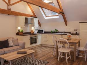 a kitchen and living room with a couch and a table at The Carriage House in Shrewsbury