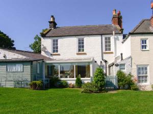 a large white house with a green yard at Croft View in Whitby