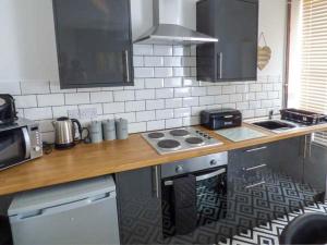 a kitchen with a counter top with a stove top oven at Flat 2 in Bridlington