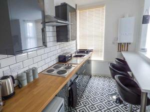 a kitchen with a counter and a stove top oven at Flat 2 in Bridlington