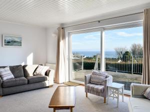 a living room with a view of the ocean at Treverrion in Gorran Haven