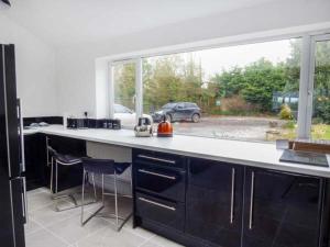 a kitchen with a counter and a large window at The Willows in Ellesmere