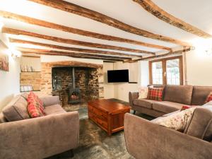 a living room with two couches and a fireplace at Lower West Curry Farmhouse in Launceston