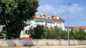 a large white house with a red roof at Apartment Luna in Srima