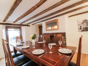 a dining room with a wooden table and chairs at Lower West Curry Farmhouse in Launceston