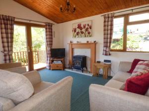 a living room with two couches and a fireplace at North Lodge in Staveley