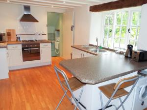 a kitchen with white cabinets and a counter top at The Granary in Ross on Wye