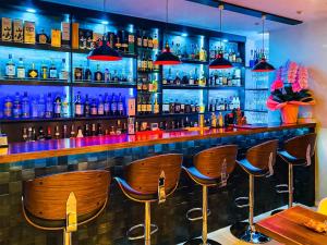 a bar with wooden bar stools in a room at Kiba no Tsuru Carane Hotel - Vacation STAY 09997v in Tokyo