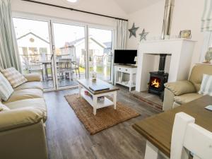 a living room with a couch and a fireplace at Sea Dog in Filey