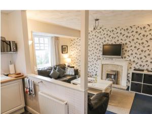 a living room with a couch and a fireplace at Quarterdeck in Scarborough