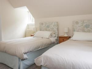 a bedroom with two beds and a window at East Lodge in Walkerburn