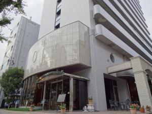 a store front of a building in a city at Kobe Luminous Hotel in Kobe