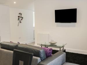 a living room with a couch and a table at Hoden View in Cleeve Prior