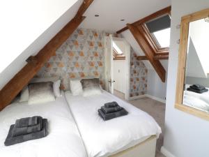 a bedroom with two beds in a attic at Avalon in Stonehouse