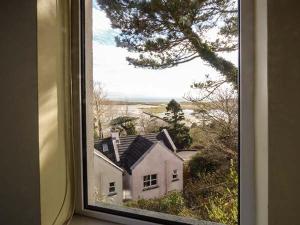 a window with a view of a white house at Number 12 in Mulranny