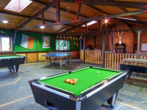 a billiard room with a pool table and two tables at Cabin 2 in Glen