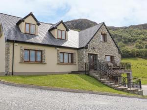 a home with a stone house with a hill in the background at Mulroy View in Burnfoot