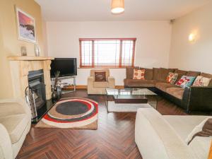 a living room with a couch and a fireplace at Mulroy View in Burnfoot