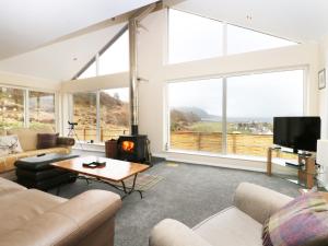 a living room with a couch and a fireplace at Torgorm in Glenelg