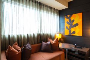 a living room with a couch and a window at KOKO HOTEL Fukuoka Tenjin in Fukuoka