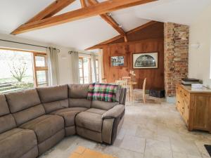 a living room with a couch and a table at The Old Dairy in Newnham