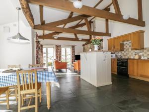 a kitchen with a table and a kitchen with wooden cabinets at Buttermere in Cockermouth