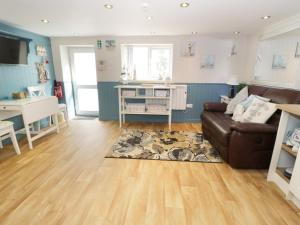 a living room with a couch and a table at The Hideaway in Benllech