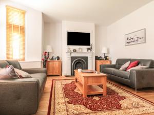 a living room with two couches and a fireplace at 33 Crescent Gardens in Bath