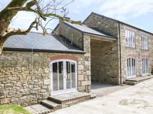 a stone house with a solarium on top of it at Dexter in Penryn