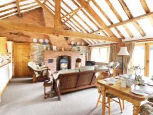 a living room with a couch and a fireplace at Sunset Cottage in Great Edston +16 photos