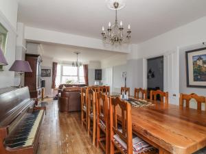 a dining room and living room with a wooden table and chairs at Lighthouse View in Great Yarmouth