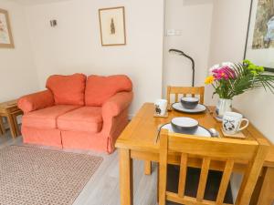 a living room with a couch and a table at The Nest in Llangollen