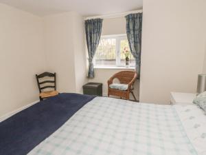 a bedroom with a bed and a window at The Nest in Llangollen