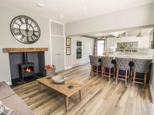 a living room with a fireplace and a clock on the wall at Lake View in Penrith