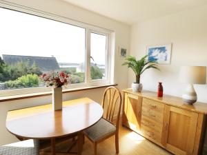 a dining room with a table and a window at Merrydown in Harlech